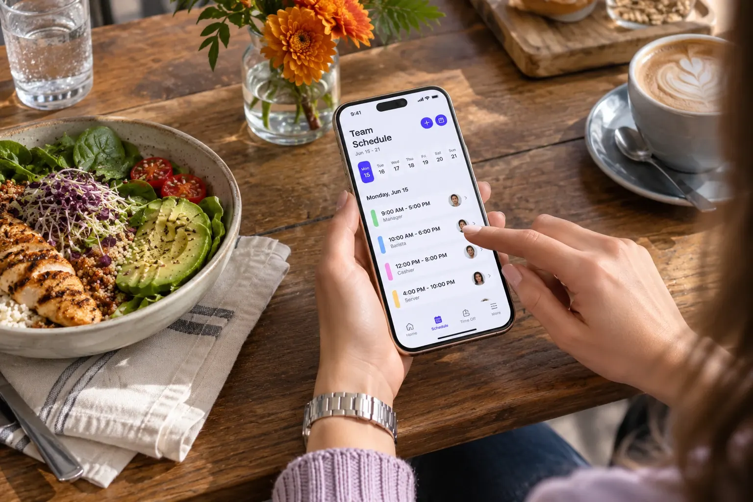A team member checking their shift schedule on the Staff Scheduling mobile app at a café
